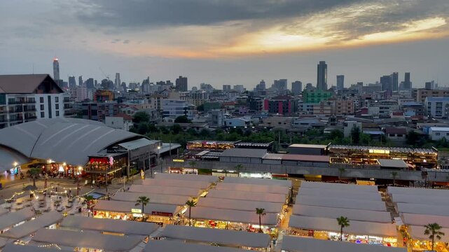BANGKOK, THAILAND - AUGUST 2024 : View of shops and food stalls at &ldquo;The One Ratchada night market&rdquo; in sunset.