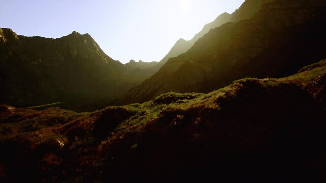 The sun casts its light on the mountains far away, creating a stunning display of natural beauty.