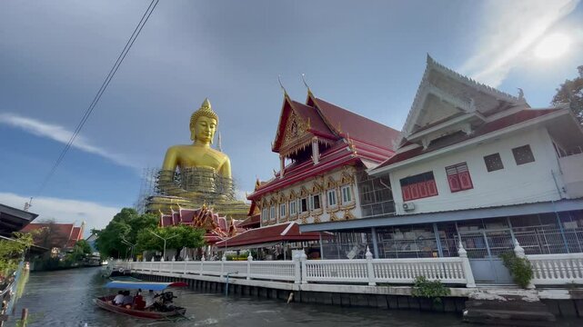 BANGKOK, THAILAND - AUGUST 2024 : View of Giant Golden Buddha at Wat Paknam. Royal temple located in Phasi Charoen district at the Bangkok Yai river.