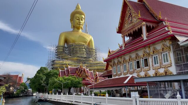 BANGKOK, THAILAND - AUGUST 2024 : View of Giant Golden Buddha at Wat Paknam. Royal temple located in Phasi Charoen district at the Bangkok Yai river.