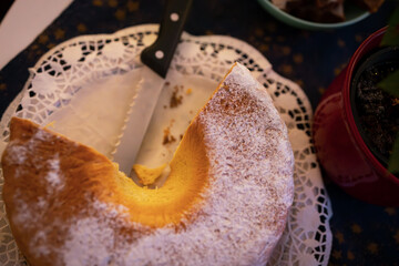 Sliced Traditional Christmas Cake with Knife on Festive Table Setting