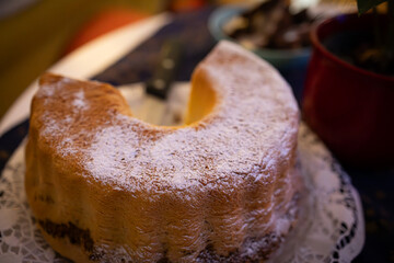 Traditional Slovenian Potica Cake with Powdered Sugar on Festive Table