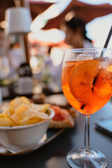 Refreshing Aperol Spritz with Snacks at Outdoor Cafe