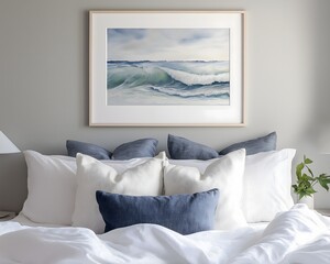 Ocean wave painting on bedroom wall above pillows in neutral tones