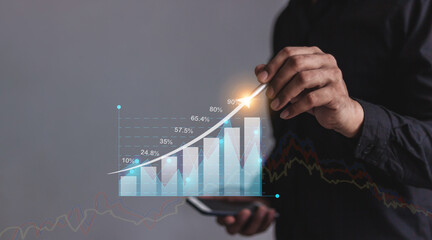 Young man with smartphone mobile hand hold a pen touching to visualize money growth The phone...