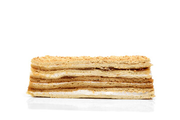 Slice of honey cake isolated on white background.