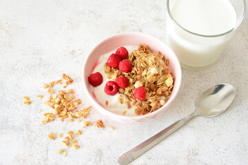 Granola Yogurt Breakfast with Raspberries and Milk and spoon flat lay
