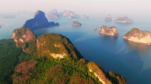 Nang Chee Phang Nga archipelago in Thailand, aerial view with amazing sunset light, drone backwards.