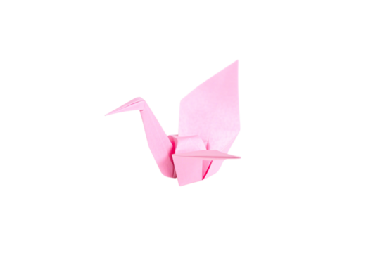 A delicate pink origami crane, its folded wings gracefully extended, symbolizes hope, peace, and the timeless beauty of Japanese paper craftsmanship, isolated on a transparent background