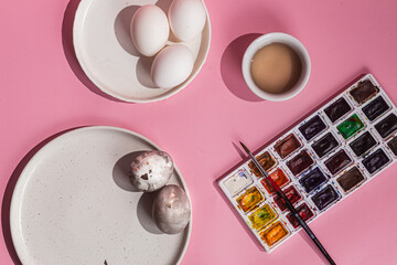 painted chicken eggs for Easter on a pink background
