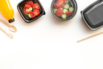 Healthy food delivery in takeaway boxes with and disposable cutlery, top view