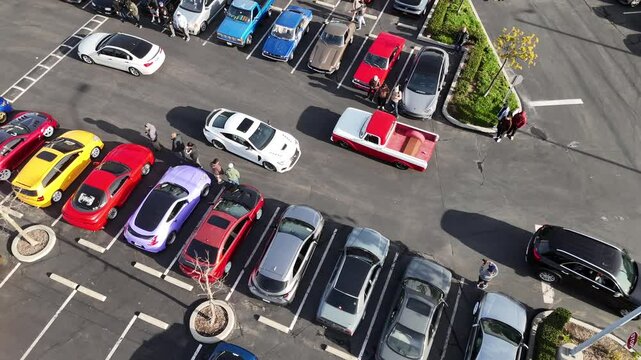 supercars, vintage and modern cars parked while other cars are passing between in Carson, California