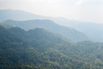 Fototapeta premium Dust pm 2.5 and Mist Clouds, High Angle Landscape view over Forest Mountains at Doi Langka Noi, Khun Chae National Park Northern Thailand.