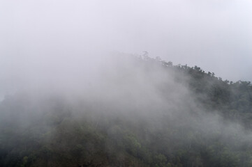Obraz premium Dust pm 2.5 and Mist Clouds, High Angle Landscape view over Forest Mountains at Doi Langka Noi, Khun Chae National Park Northern Thailand.