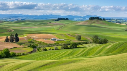 Scenic rolling green hills and fields under a cloudy sky