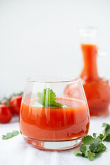 Tomato juice in a glass on a white background