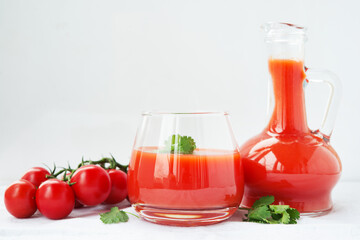Tomato juice in a glass on a white background