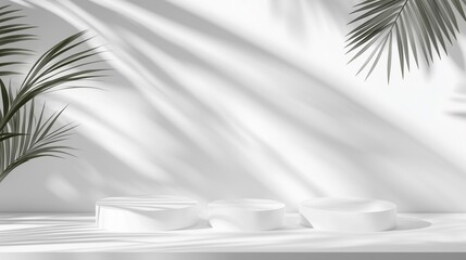 Abstract white background with the shadows of palm leaves on the wall and three podiums for product presentation.