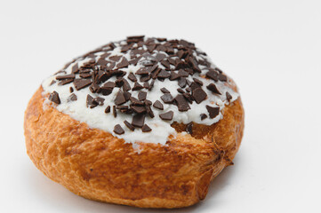 freshly baked sweet cinnamon roll isolated on white background, top view