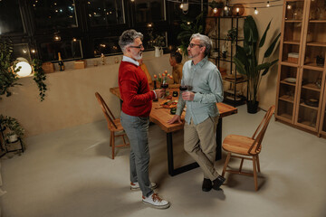 Senior friends celebrating pension with wine and good company