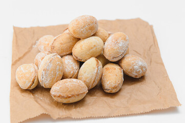 Delicious nut shaped cookies with boiled condensed milk on white background