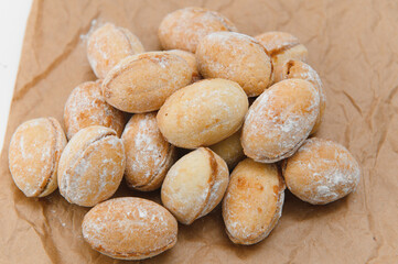 Delicious nut shaped cookies with boiled condensed milk on white background