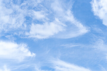 Low angle view and full frame of beautiful blue sky with strange shape of white fluffy of clouds in the morning or evening on sunny day used as natural background texture in decorative art work