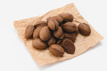 Delicious nut shaped cookies with boiled condensed milk on white background