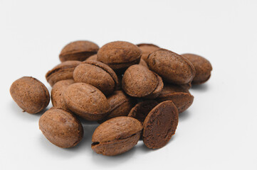 Delicious nut shaped cookies with boiled condensed milk on white background