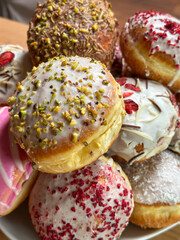 homemade donuts with icing sugar colored icing and sprinkles
