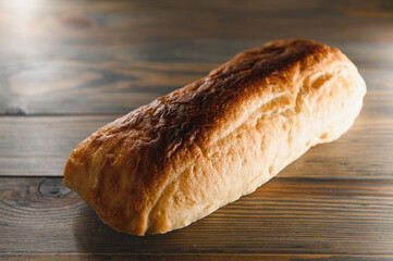 Fresh bread isolated on a wooden background