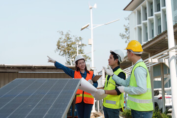Renewable energy teamwork. Engineers discussing installation strategies at a solar power site.