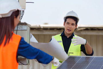 Engineer explaining solar installation plans. Discussing sustainable energy technology with a colleague.
