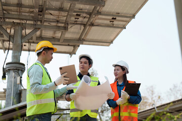 Sustainable technology. Engineers reviewing energy project plans with a focus on collaboration.