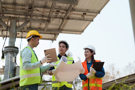 Sustainable technology. Engineers reviewing energy project plans with a focus on collaboration.