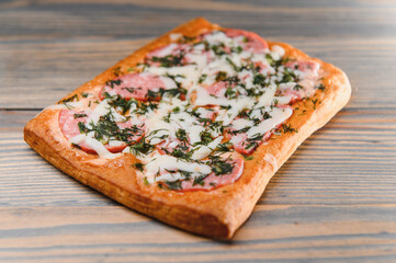 Tasty mini pizza on a wooden background