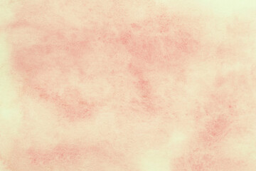 close up of yellow with pink watercolor splashes on paper