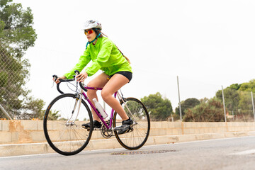 Obraz premium Professional cyclist training on road bike with helmet and sunglasses