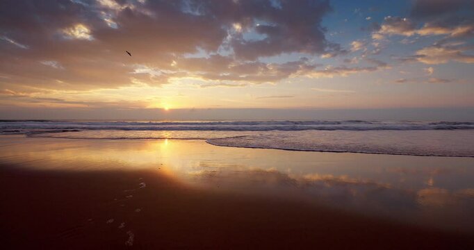  Sunset over ocean beach shore with splashing waves on the sand. Sea sunrise video 