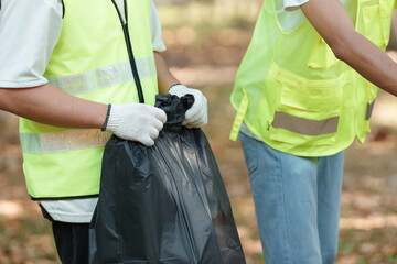 Active participation. Volunteers engaging in garbage collection for a cleaner future.