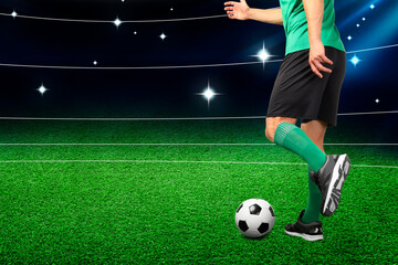 Man playing football with soccer ball on artificial grass at stadium, closeup