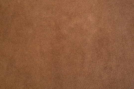 Genuine leather suede skin, textured surface, brown close up parchment structure , abstract backdrop