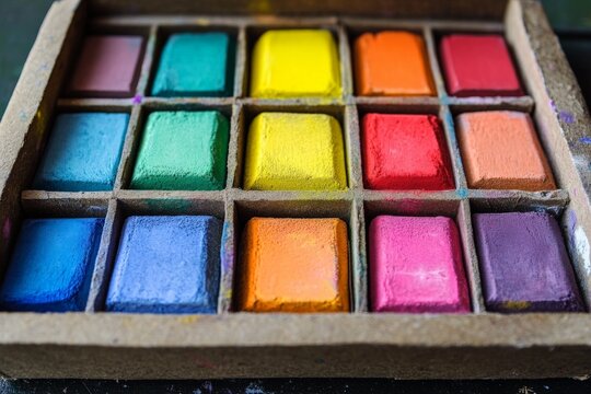 Colorful pastels arranged in a neat grid for creative artistic projects and activities
