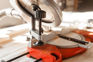 Circular saw in use cutting a wooden plank inside a workshop. The image highlights the precision and efficiency of the tool, emphasizing its role in woodworking projects and carpentry.