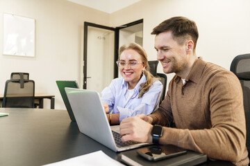 Collaborative work session in modern office with young professionals engaged in discussion and planning