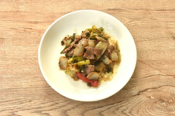 spicy stir fried ostrich meat with onion and black pepper on plate 