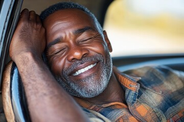 A peaceful man sleeping in a car with his eyes closed and a gentle smile