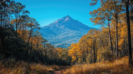 Naklejka premium Majestic mountain surrounded by vibrant autumn foliage in serene landscape