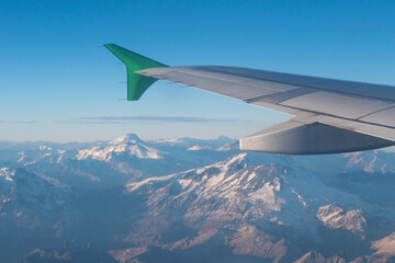 Fototapeta premium The Andes Mountains as seen from the window of a commercial airliner at sunset. 