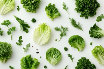 Fresh assortment of crisp greens and herbs laid out on a white background for healthy eating inspiration
